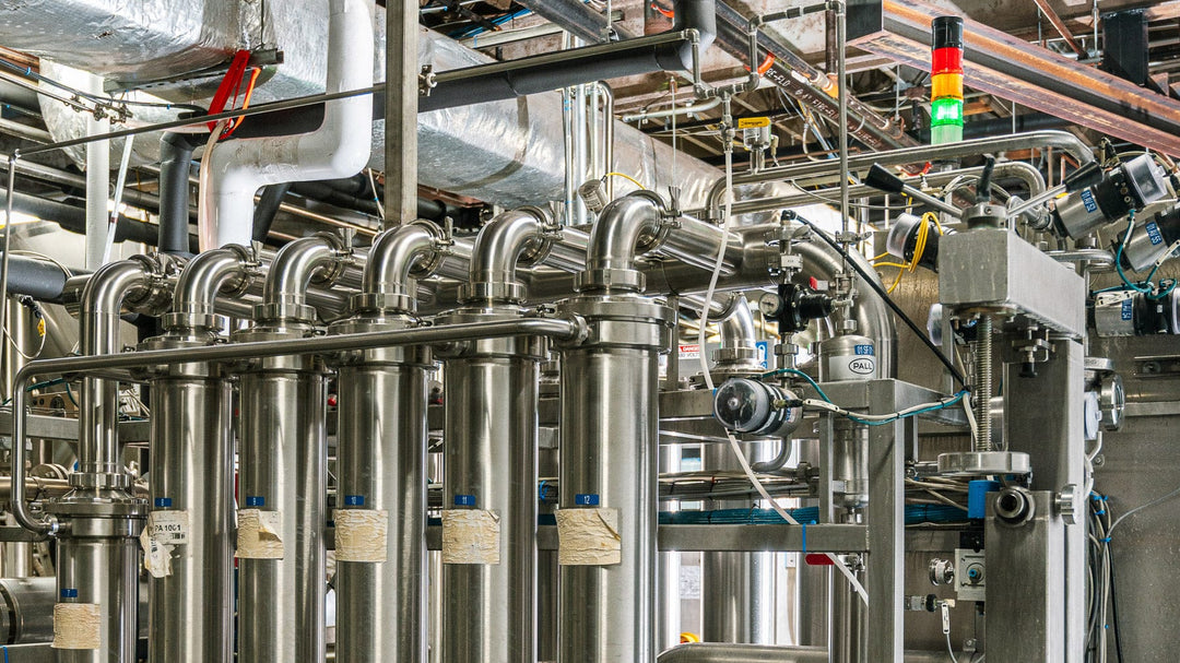 Industrial setting with metallic pipes and machinery in a factory
