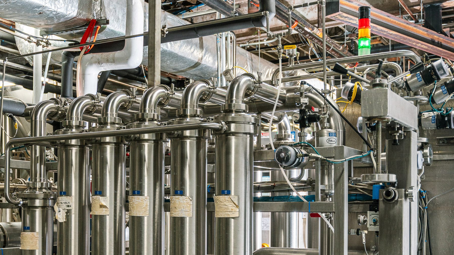 Industrial setting with metallic pipes and machinery in a factory