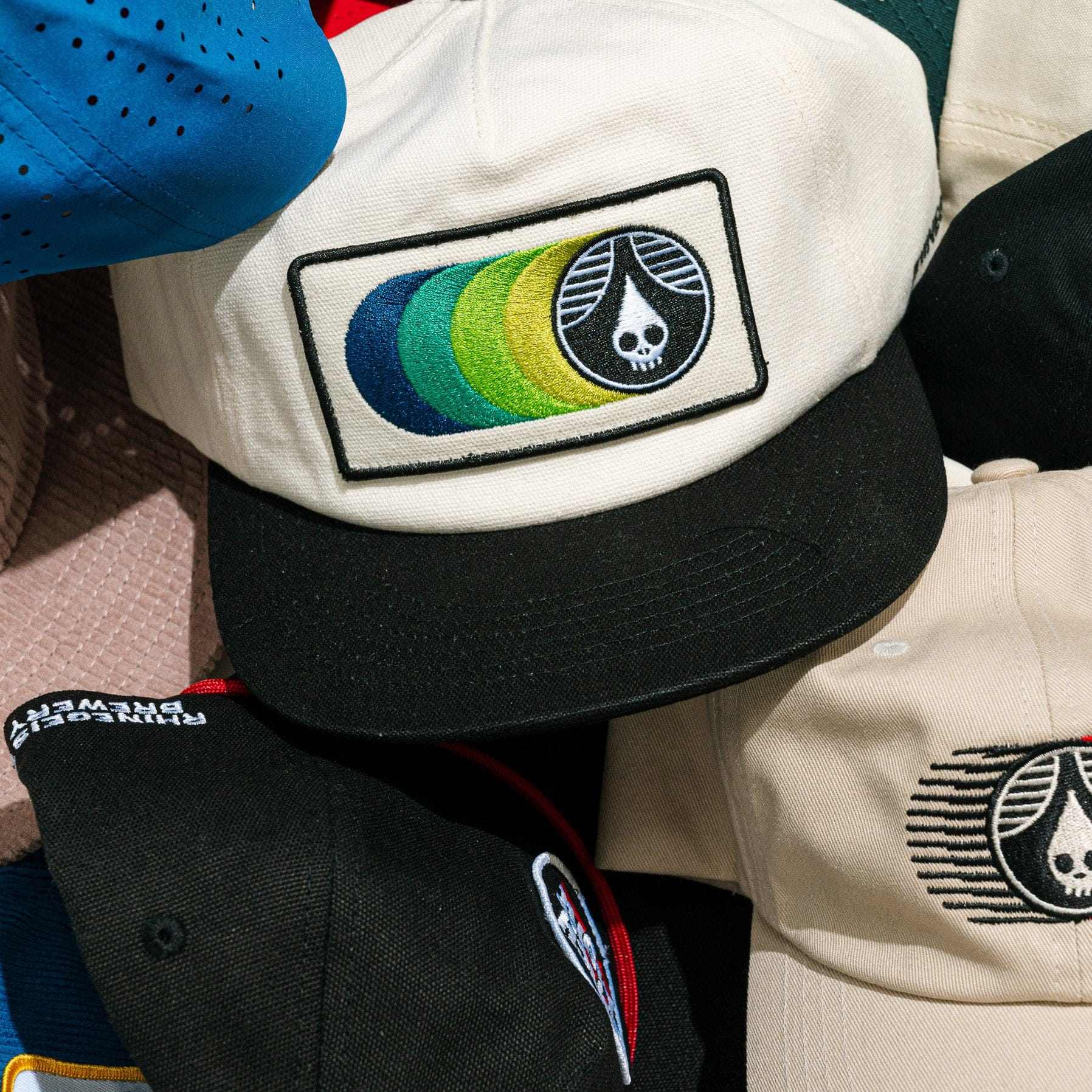 Close-up of a cap with a colorful logo and text on a jacket.