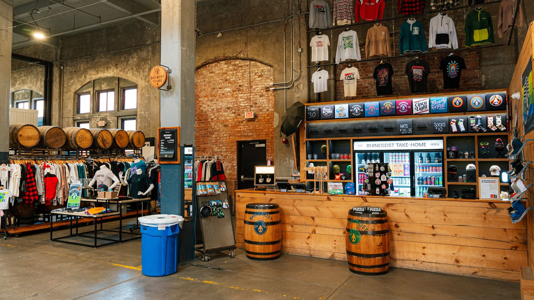 Interior of a store with various clothing items displayed on racks and shelves.